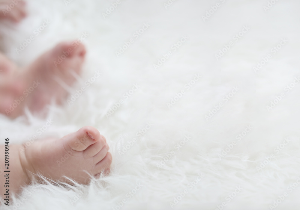baby feet on white blanket. copy space. selective focus baby feet on white blanket. copy space. selective focus