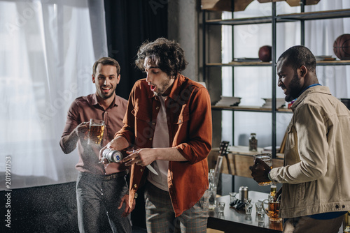 happy young make friends drinking beer together indoors