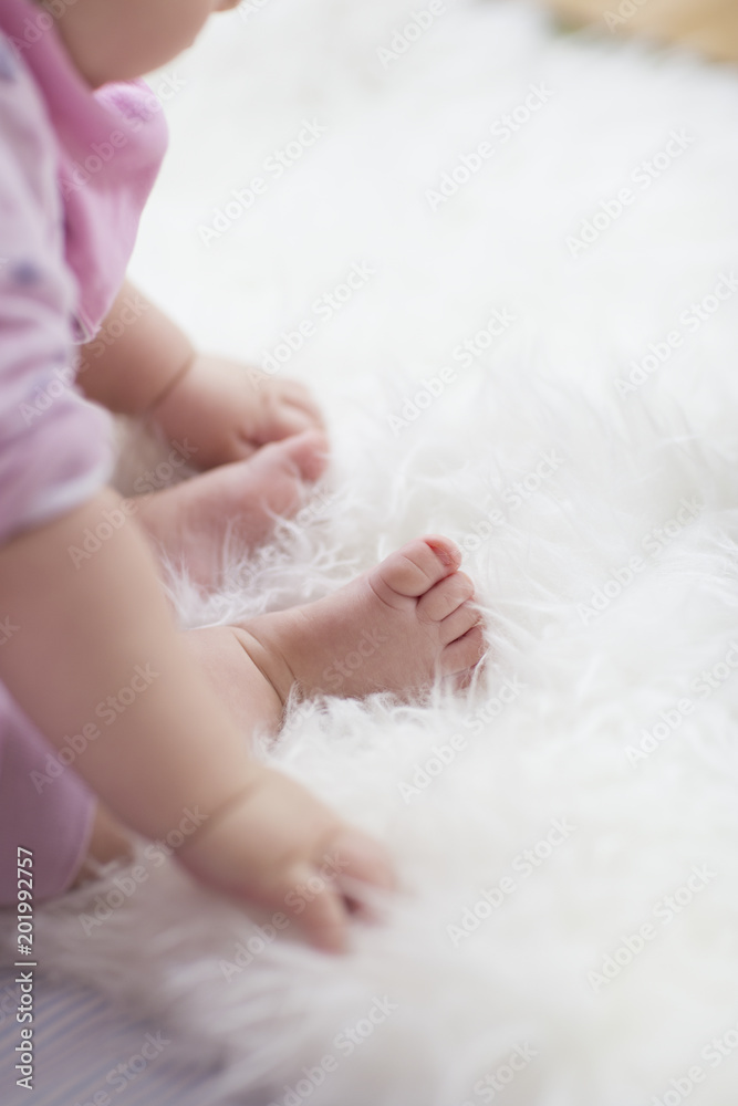 baby feet on white blanket. copy space. selective focus baby feet on white blanket. copy space. selective focus