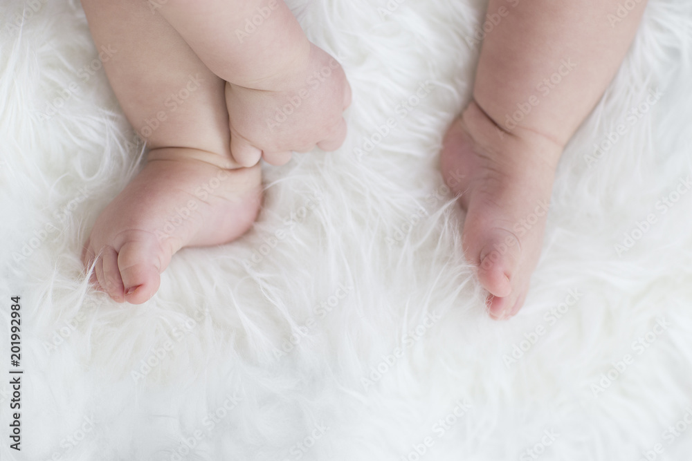 baby feet on white blanket. copy space. selective focus baby feet on white blanket. copy space. selective focus