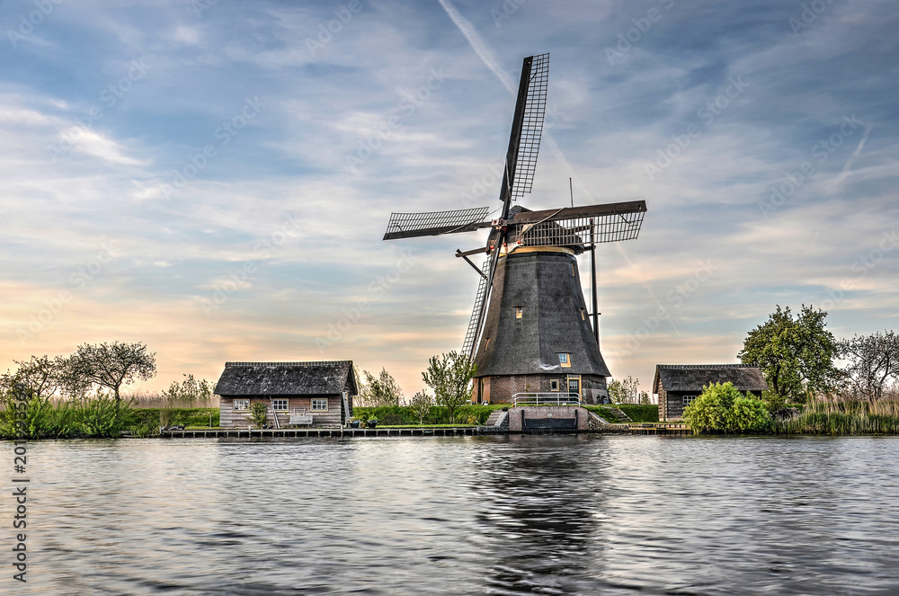 One of the 19 windmills at Kinderdijk Unesco world heritage site at the edge of a canal