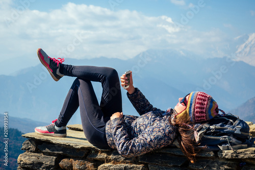 beautiful and active woman rests in trekking in the mountains. the concept of active recreation and tourism in the mountains. trekking in Nepal Himalayas photo