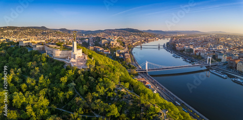 Budapest, Hungary - Aerial panoramic skyline view of Budapest at sunrise. This view includes the Statue of Liberty, Elisabeth Bridge, Buda Castle Royal Palace and Szechenyi Chain Bridge with blue sky photo