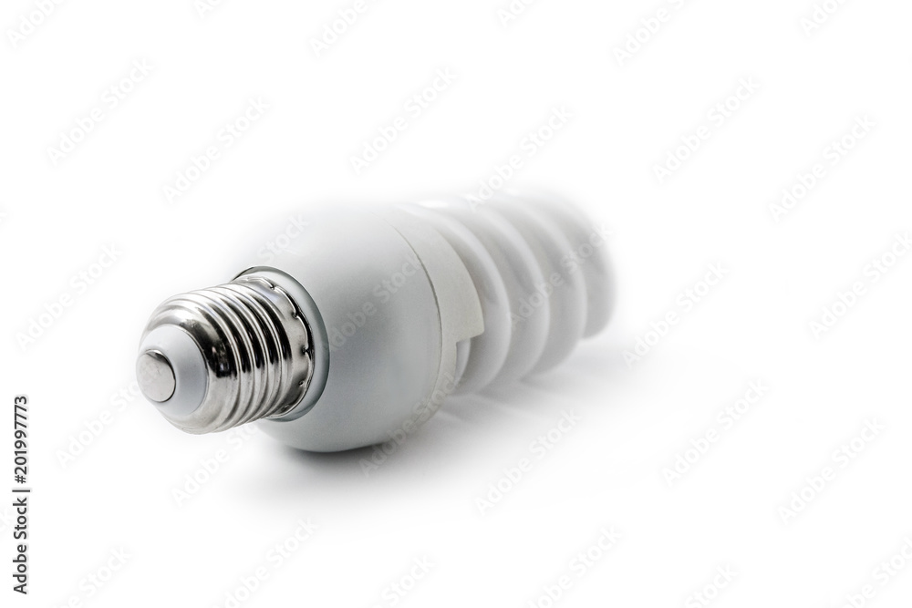 Energy saving fluorescent spiral light bulb on white background. Diagonal view. Shallow depth of field. Energy saving fluorescent spiral light bulb on white background. Diagonal view. Shallow depth of field.