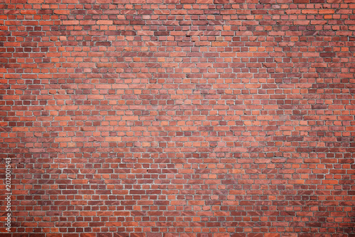 Big full frame background of detailed old red brick wall with vignette. Copy space.