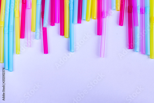 vibrant background of multicolored plastic straws  copy space