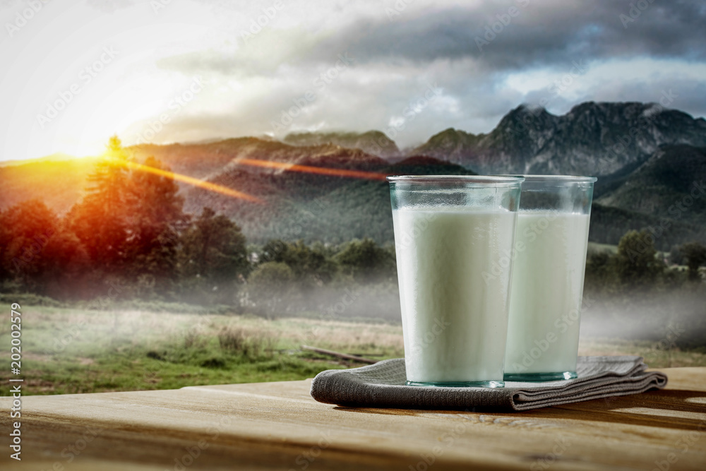 Fresh milk and landscape of mountains with fog and sunrise. Free space for your milk product. Fresh milk and landscape of mountains with fog and sunrise. Free space for your milk product.