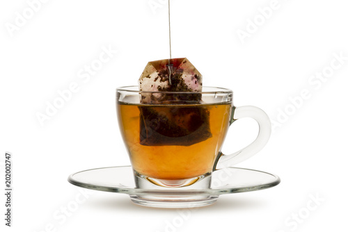 tea in glass cup with tea bag, on white background