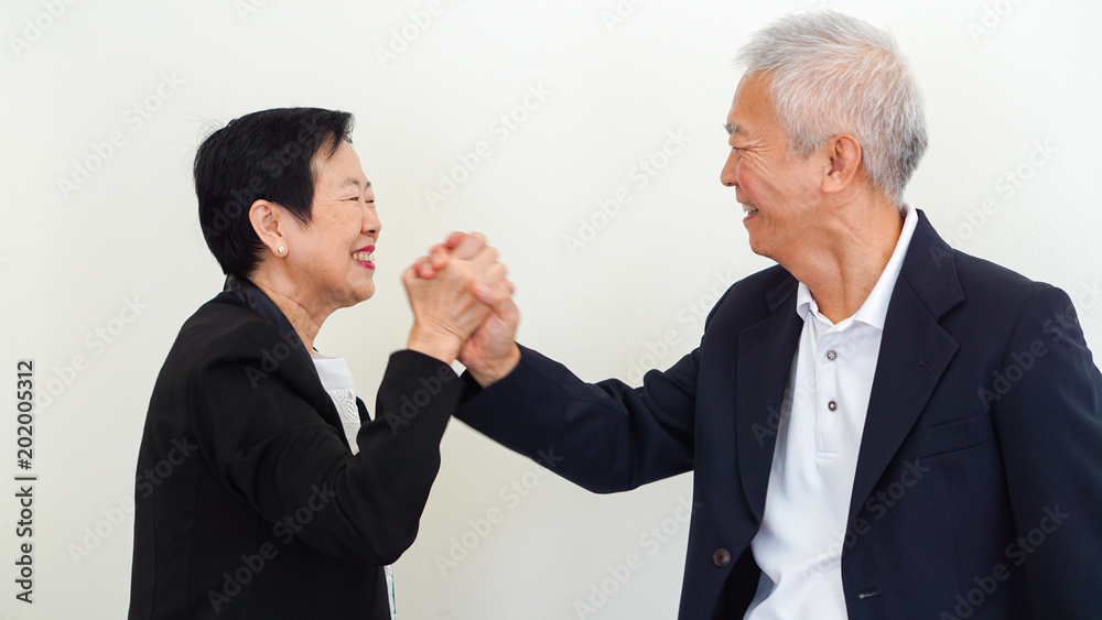 Asian senior business people couple holding hand for successful life Asian senior business people couple holding hand for successful life
