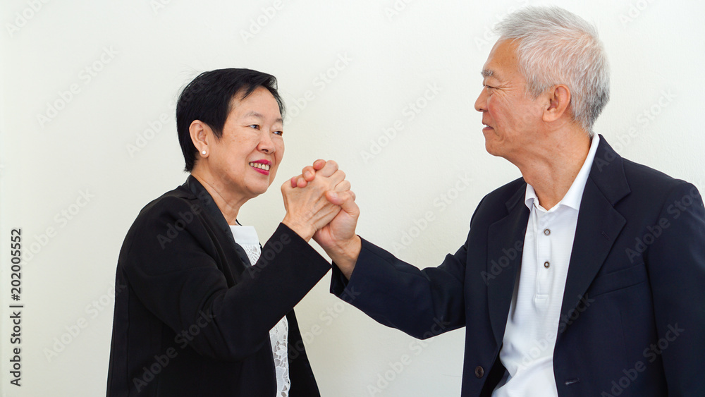 Asian senior business people couple holding hand for successful life Asian senior business people couple holding hand for successful life