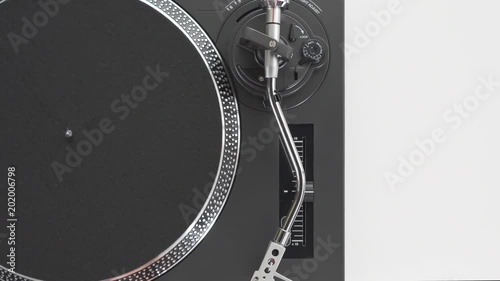 Slide the side view to the hands of the DJ's girl put a red vinyl record plate, rotating disc turntable, the needle with stylus, on a white background