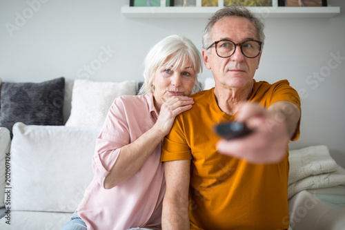 Senior marriage watching tv together