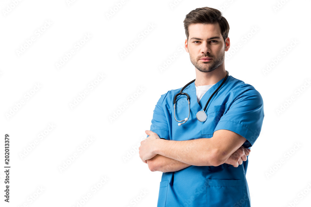 Surgeon wearing blue uniform with stethoscope standing with folded arms isolated on white Surgeon wearing blue uniform with stethoscope standing with folded arms isolated on white