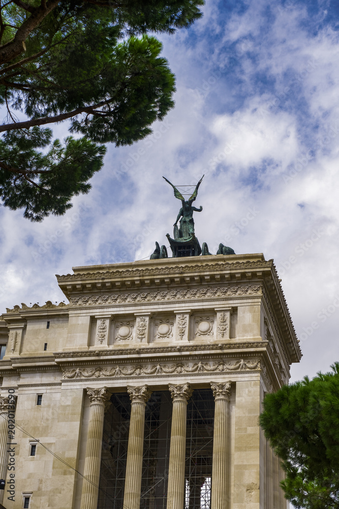 Fototapeta premium Rome, Italy winged statue of goddess Victoria on top of Altare della Patria monument. Bronze statue silhouette at Monumento Nazionale a Vittorio Emanuele II.