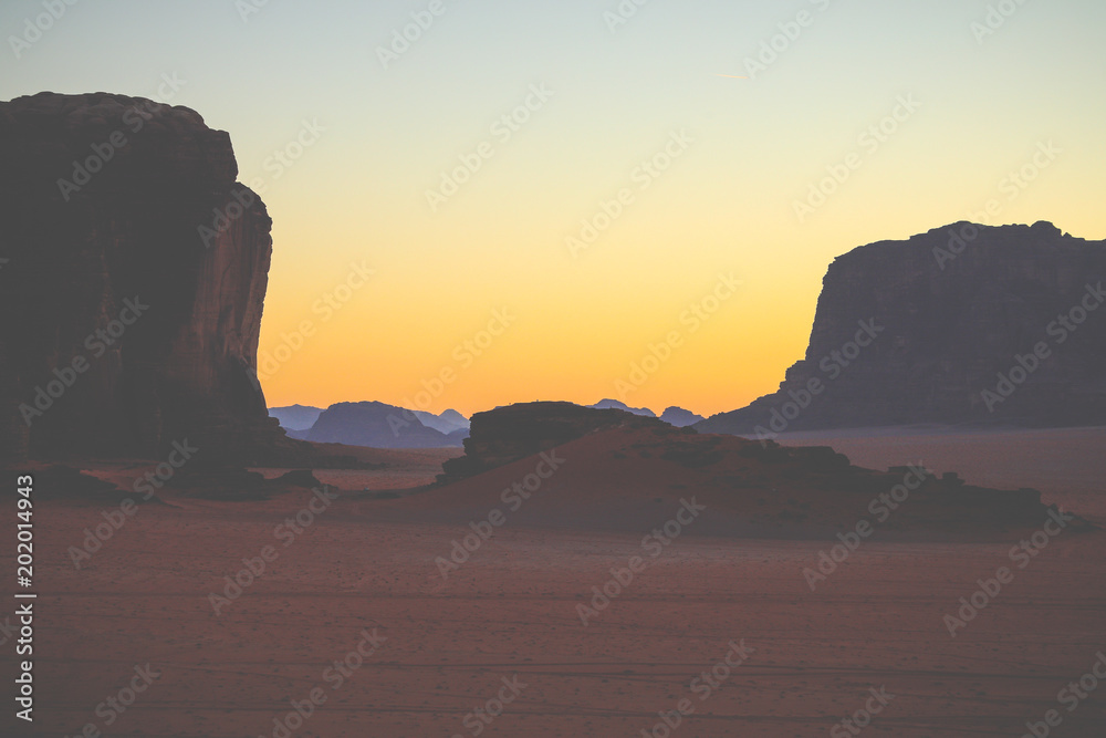 Wadi Rum in Jordan at sunset. Wadi Rum is known as The Valley of the Moon and has led to its designation as a UNESCO World Heritage Site.