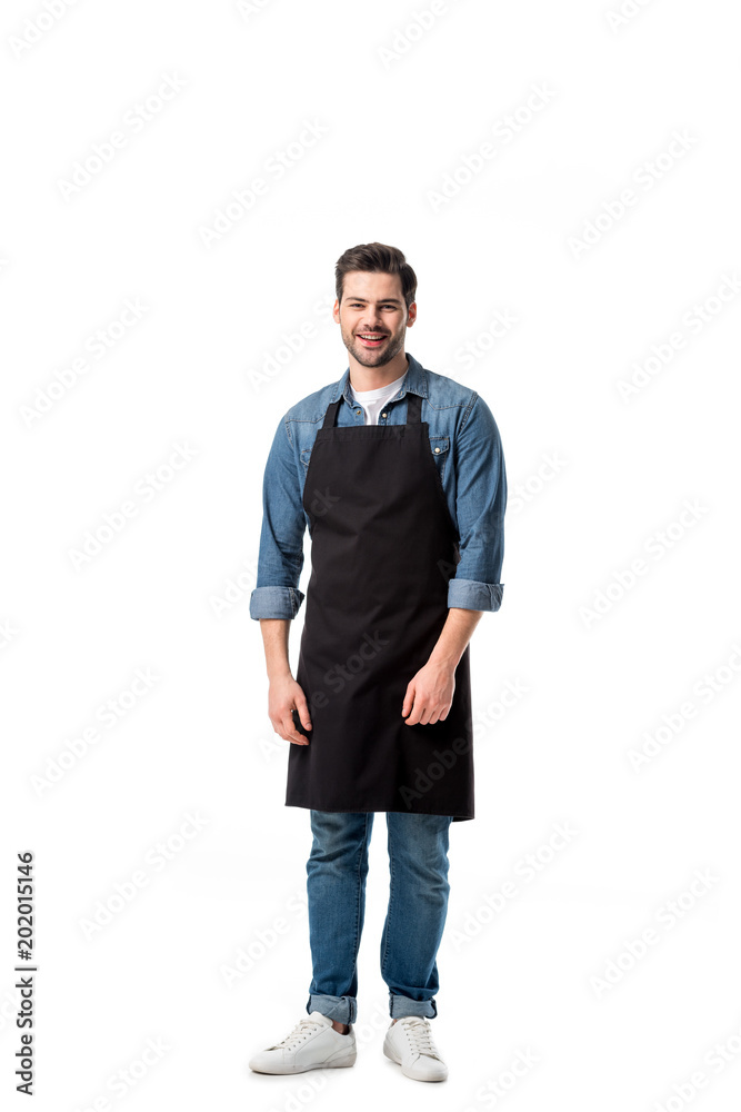 young smiling waiter in apron looking at camera isolated on white young smiling waiter in apron looking at camera isolated on white