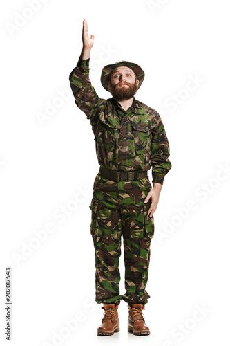 Young army soldier wearing camouflage uniform isolated on white