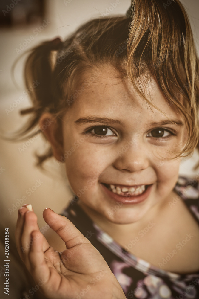 Cute little girl showing missing teeth. Looking at camera. Cute little girl showing missing teeth. Looking at camera.