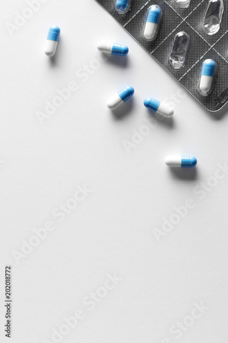 Bicolor pills near blister with copy space photo