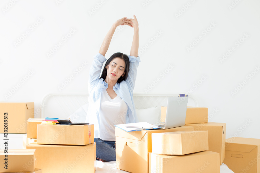 Young Asian Woman relax while work at home, Young Owner Woman Start up for Business Online. People with online shopping SME entrepreneur or freelance working concept. Young Asian Woman relax while work at home, Young Owner Woman Start up for Business Online. People with online shopping SME entrepreneur or freelance working concept.