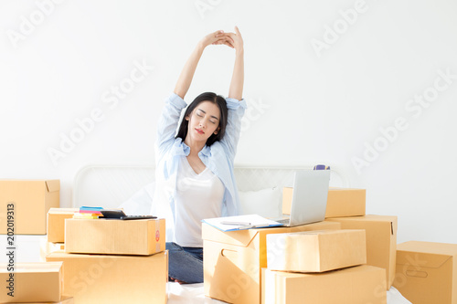 Young Asian Woman relax while work at home, Young Owner Woman Start up for Business Online. People with online shopping SME entrepreneur or freelance working concept.