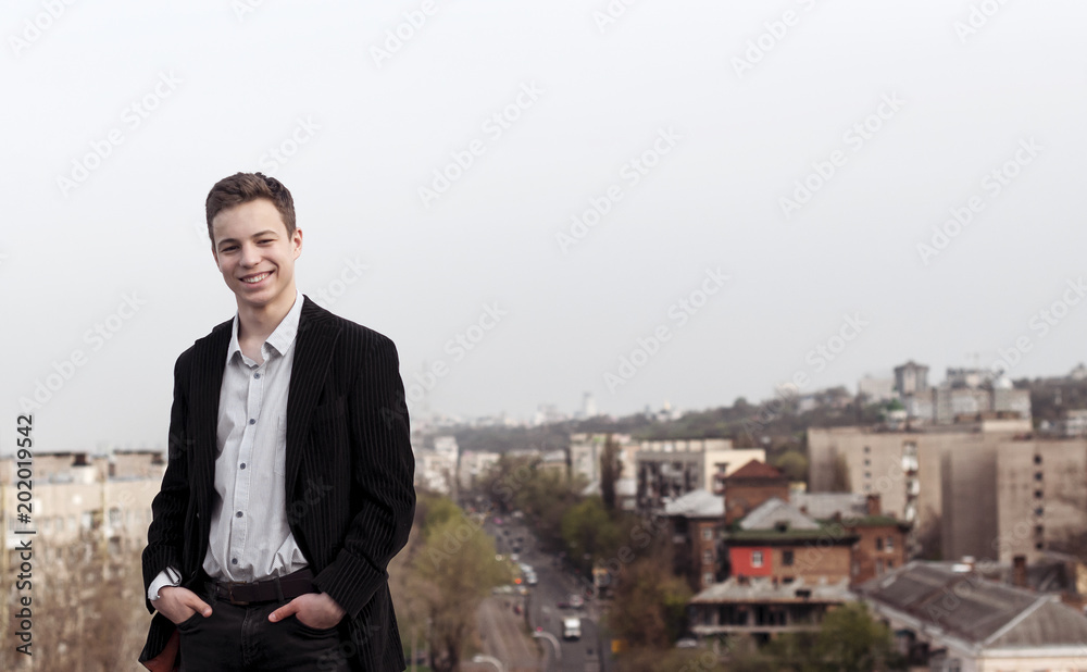 young man on the roof of a tall house young man on the roof of a tall house