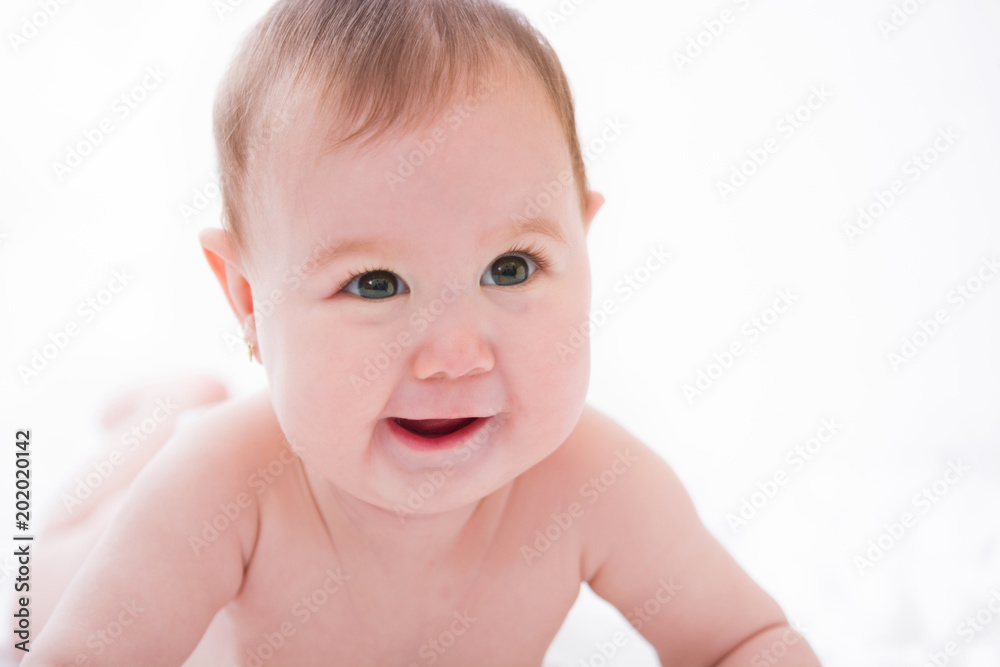 Adorable little baby girl smiling on white background. Adorable little baby girl smiling on white background.