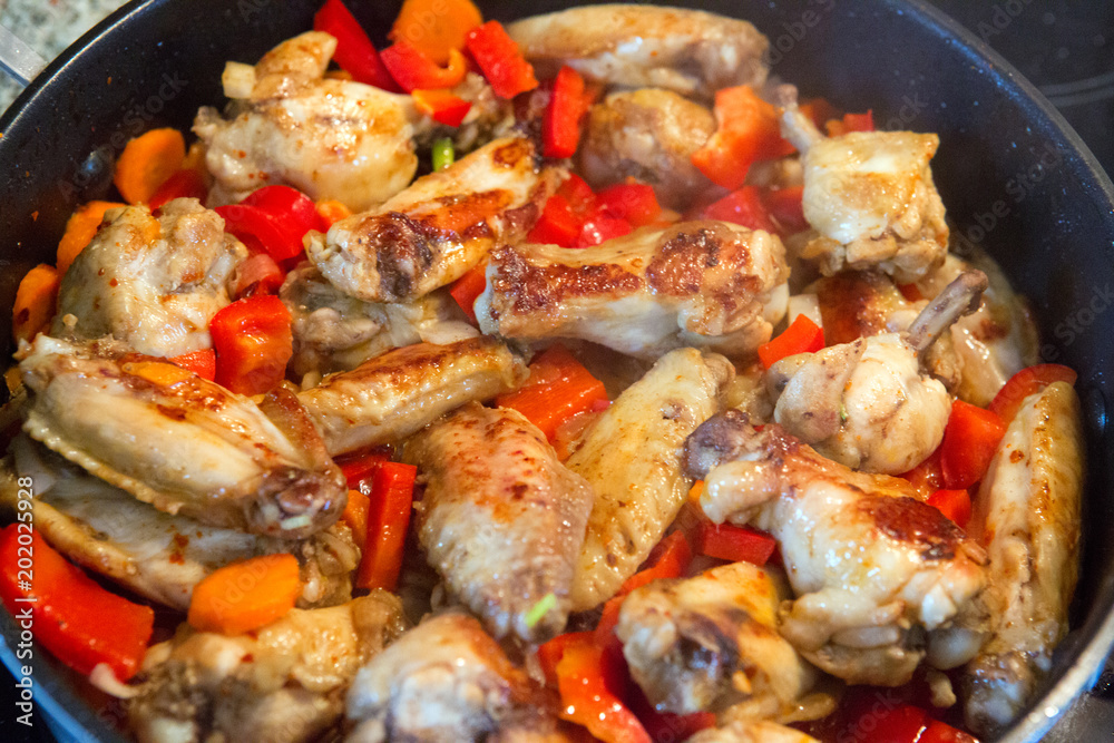 A roasted chicken pieces with vegetables . A roasted chicken pieces with vegetables .