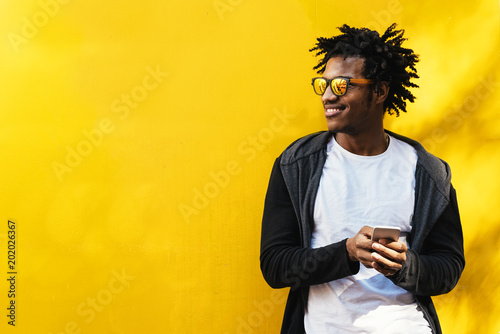 Portrait of handsome afro man using his mobile.