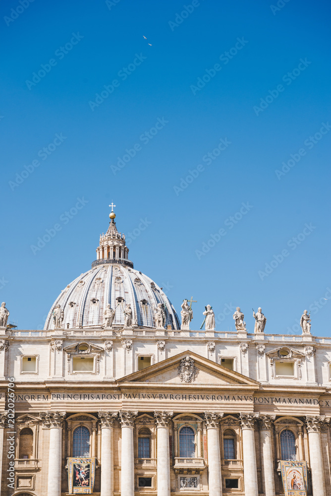 dome of St. Peter's Basilica under blue sky, Vatican, Italy