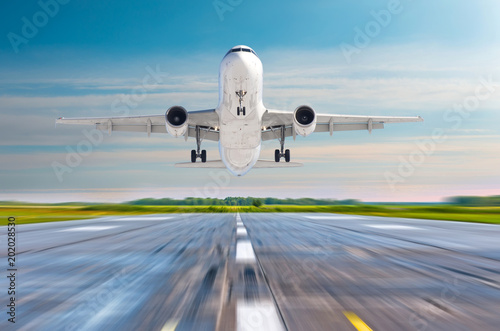 Passenger airplane landing on a runway airport.