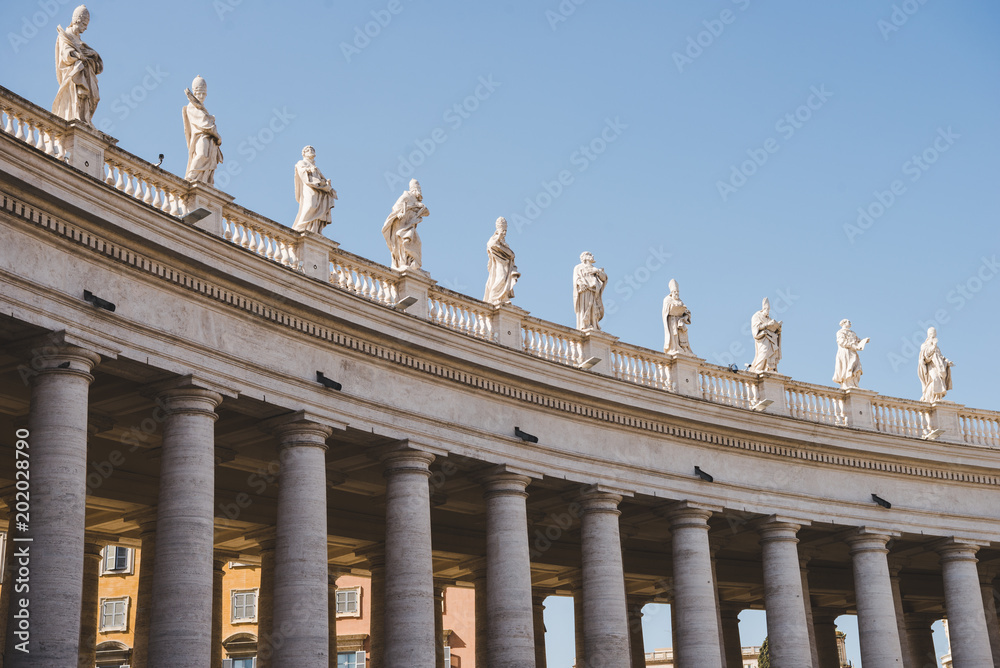 statues and columns at st peters square in Vatican, Italy