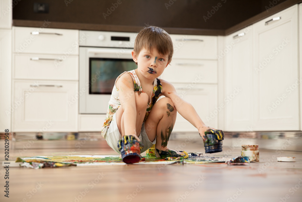 Fotografie The boy drew and smeared with paints
