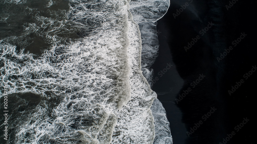 The black sand beach in Iceland. Aerial view and top view. Beautiful natural backdrop. The black sand beach in Iceland. Aerial view and top view. Beautiful natural backdrop.