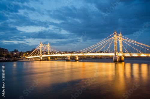 Albert Bridge and beautiful sunset over the Thames, London, England UK