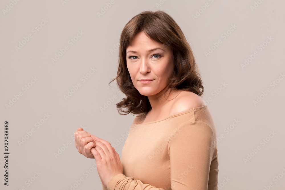Mid Age Woman Over 35 Years Old Beauty Concept Luxury Woman In Beige Blouse Standing Half Turn And Posing In Camera Stock Photo Adobe Stock