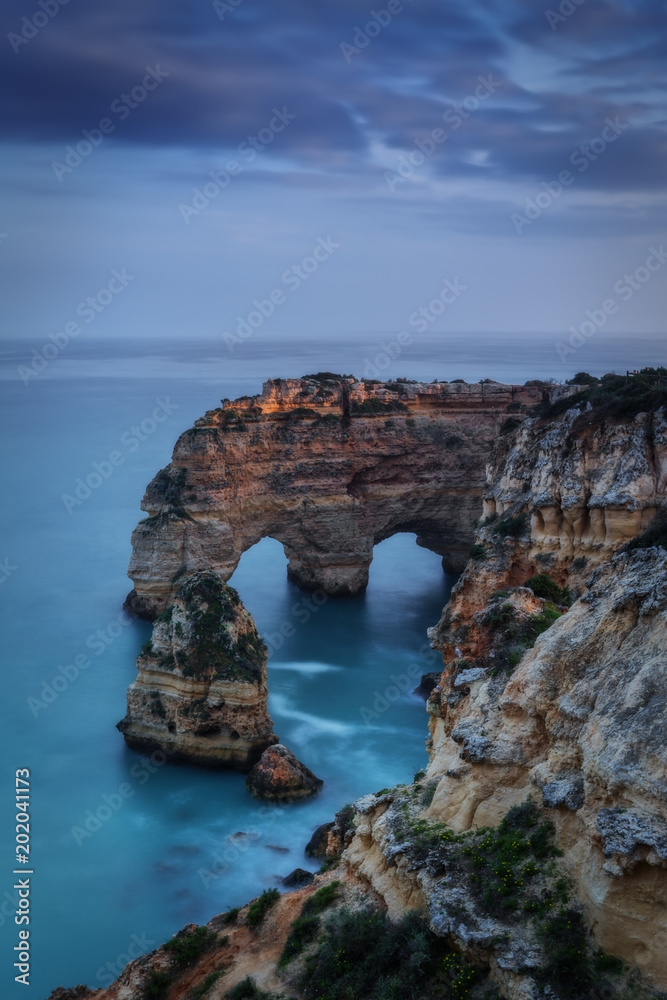 Mountains and arches in the shape of a heart on the beach Marinha.