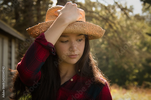 Country Girl Wearing Straw Hat and Red Flannel Shirt