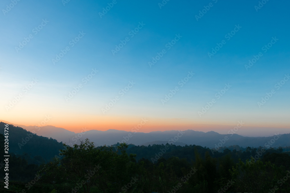 Colorful sky at sunrise with mountain  background