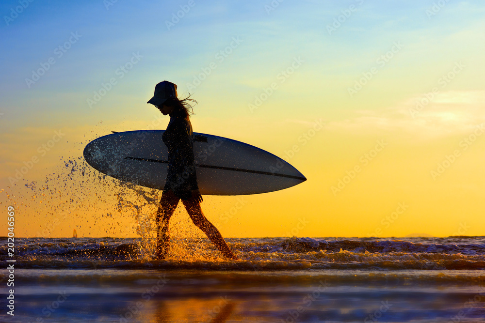 Poster Print Silhouette of woman holding surfboard beside walking on the edge of sea wave sp 40x26.7 cm
