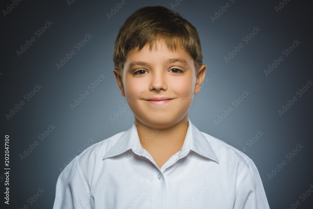 Happy child. Portrait of handsome boy smiling isolated on grey background Happy child. Portrait of handsome boy smiling isolated on grey background