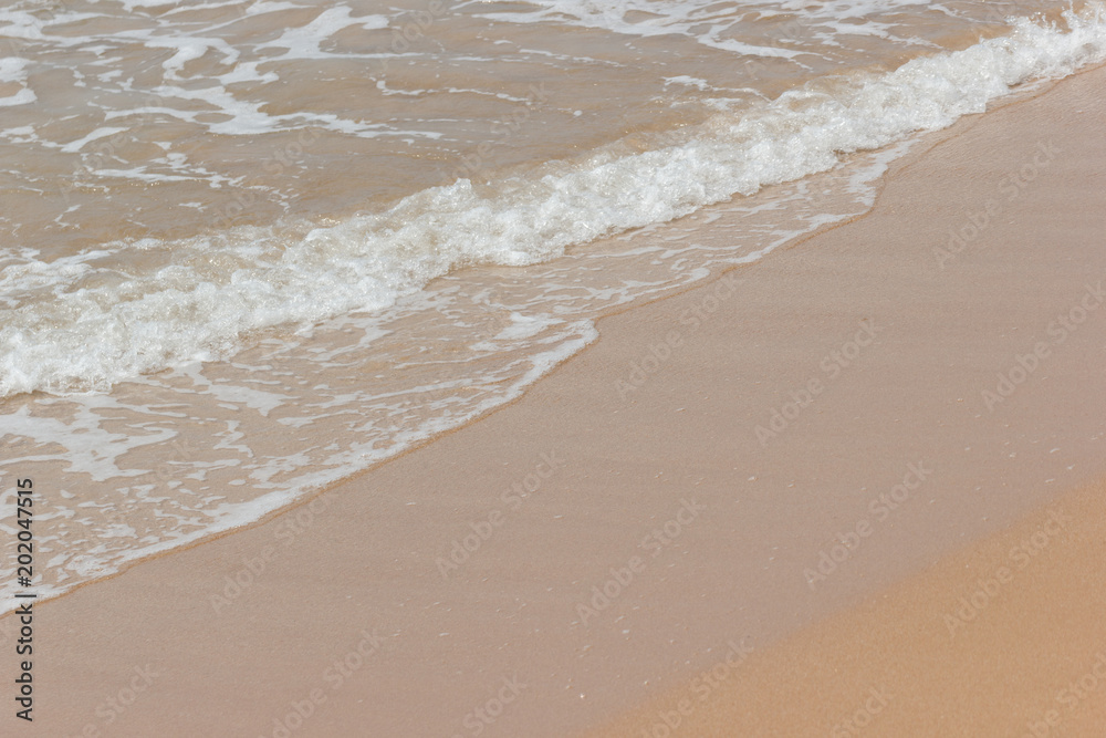 Soft wave of the blue ocean on the seashore of Thailand, copy space on the sand copy space Soft wave of the blue ocean on the seashore of Thailand, copy space on the sand copy space