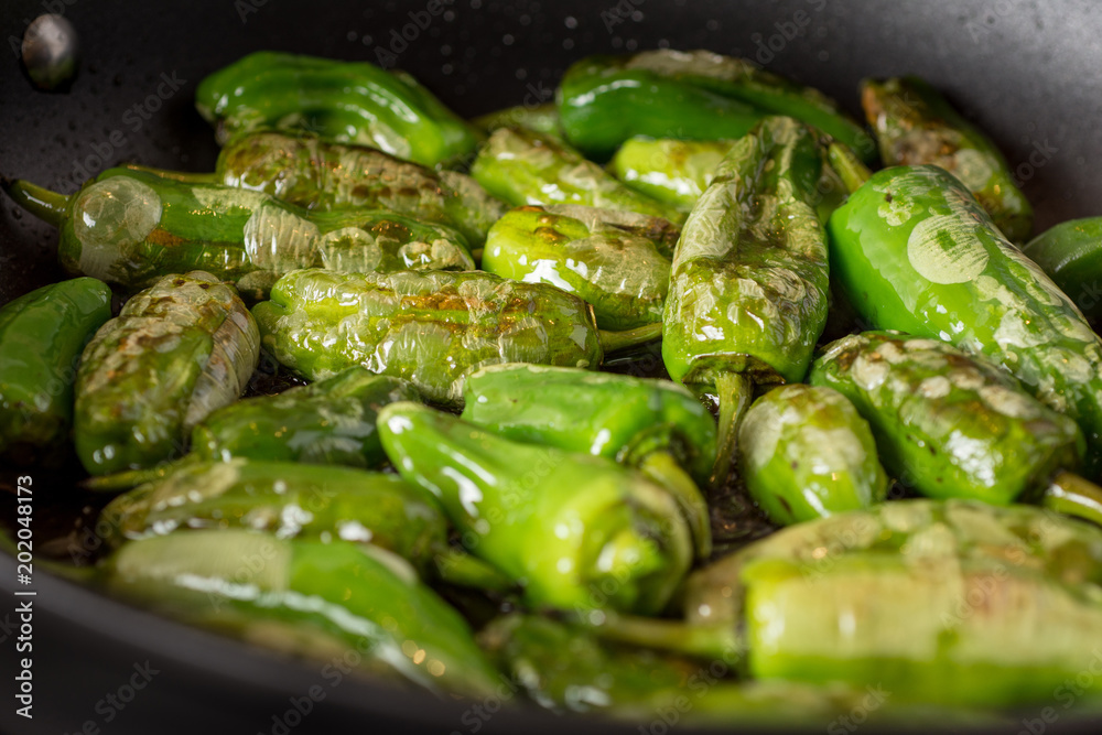 Pimientos de Padrón. Preparing Green Padron Peppers in the Frying Pan. Pimientos de Padrón. Preparing Green Padron Peppers in the Frying Pan.