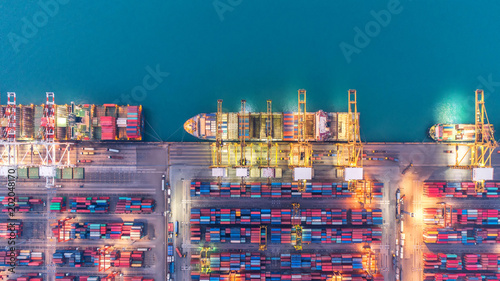 Container ship in export and import business and logistics. Shipping cargo to harbor by crane. Water transport International. Aerial view and top view. photo