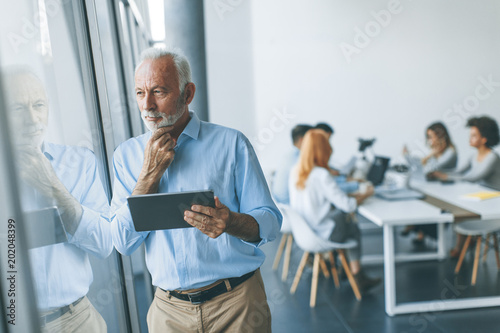 Senior businessman standing...