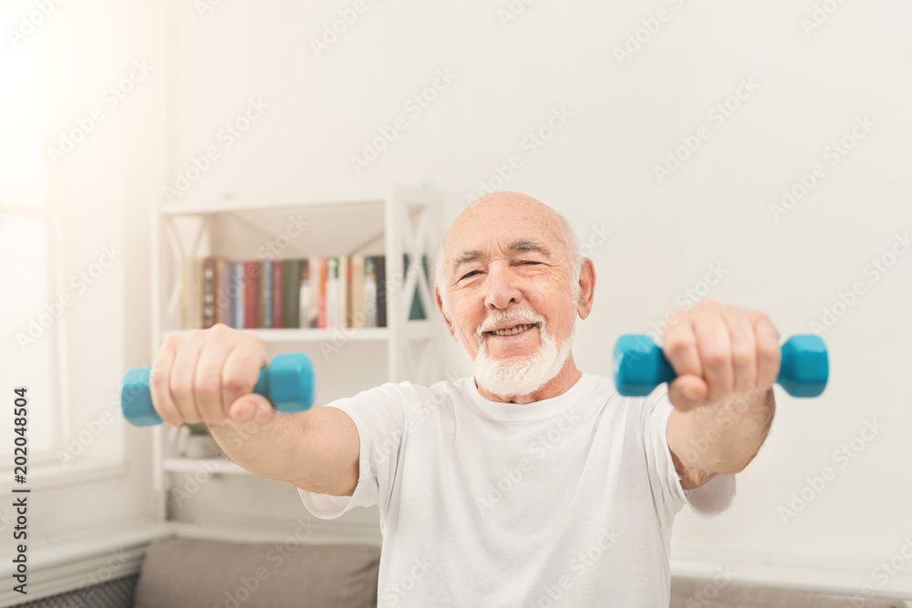 Senior man making exercise with dumbbells Senior man making exercise with dumbbells
