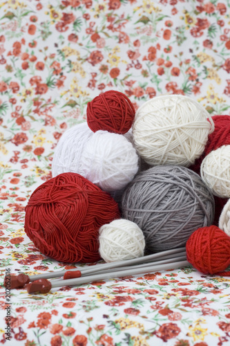 A lot of bright balls of knitting on the background 