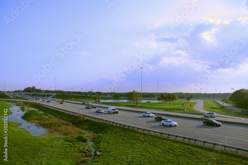 Florida Turnpike at Pompano Beach, Florida with Northbound and Southbound Rush Hour Traffic in Late Afternoon Sun