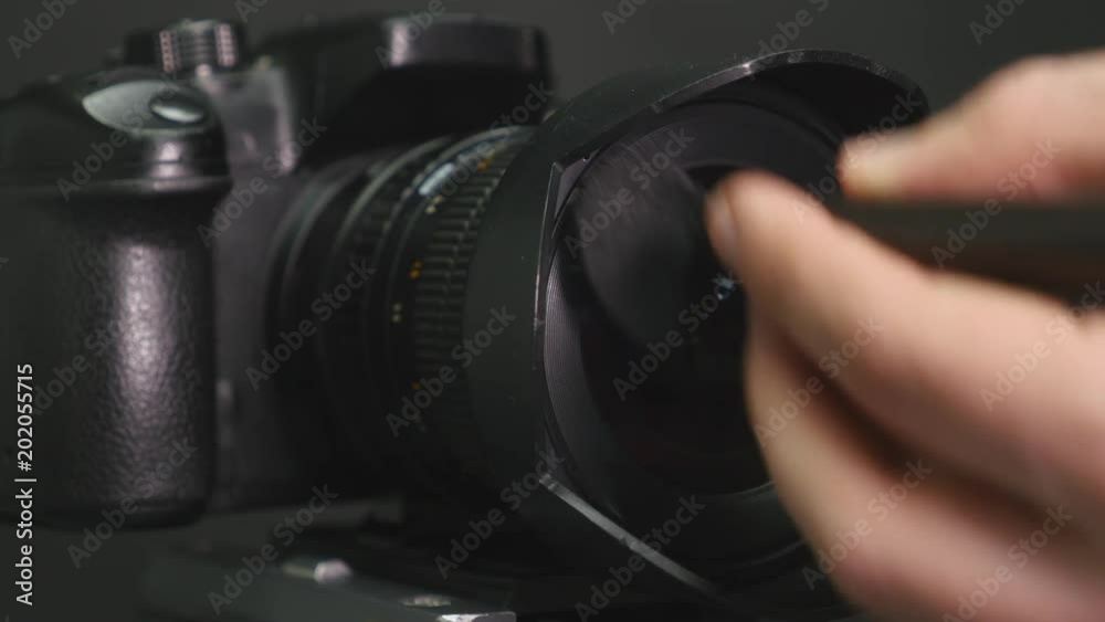 The photographer carries out cleaning of the camera lens