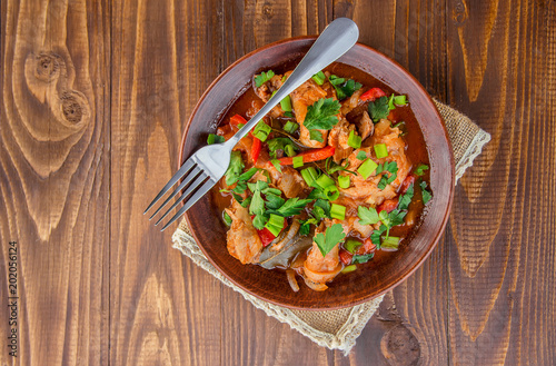 chicken stew with onion and vegetables in tomato sauce. chahohby. Selective focus  photo